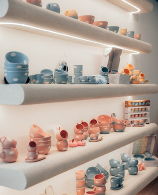 Curved plaster shelves in the Egg Back Home Porto store, lined with Cloud stoneware in blue and pink